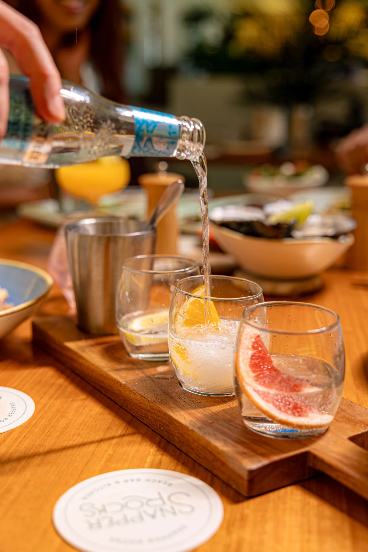 A gin tasting flight with citrus being poured at Snapper Rocks