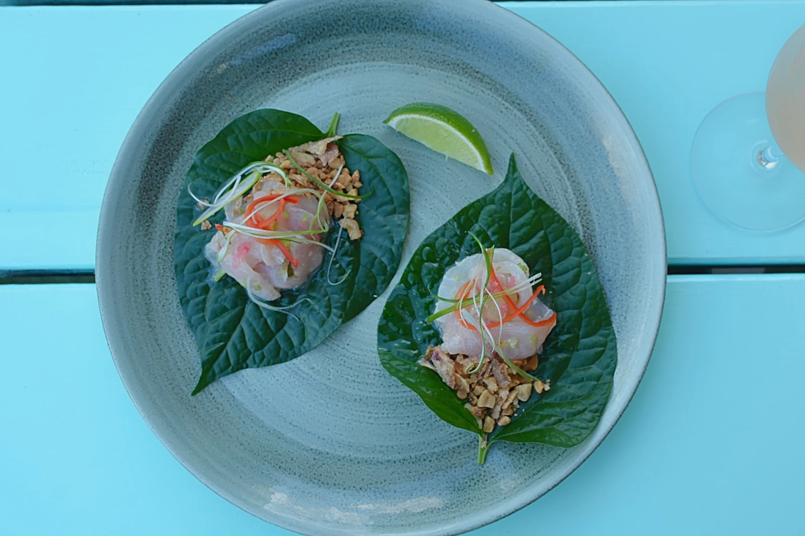 Betel leaf wraps with fish, herbs and lime at Snapper Rocks